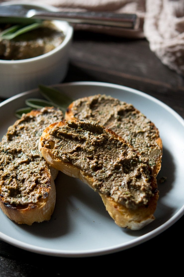 a close up of chicken liver pate spread on crusty bread