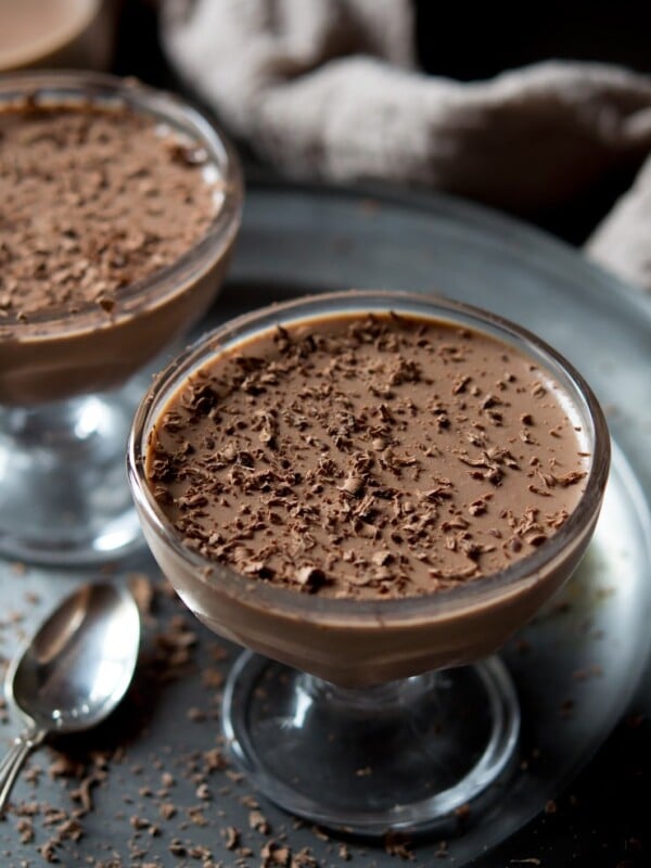 choclate panna cotta in a glass with grated dark chocolate on top