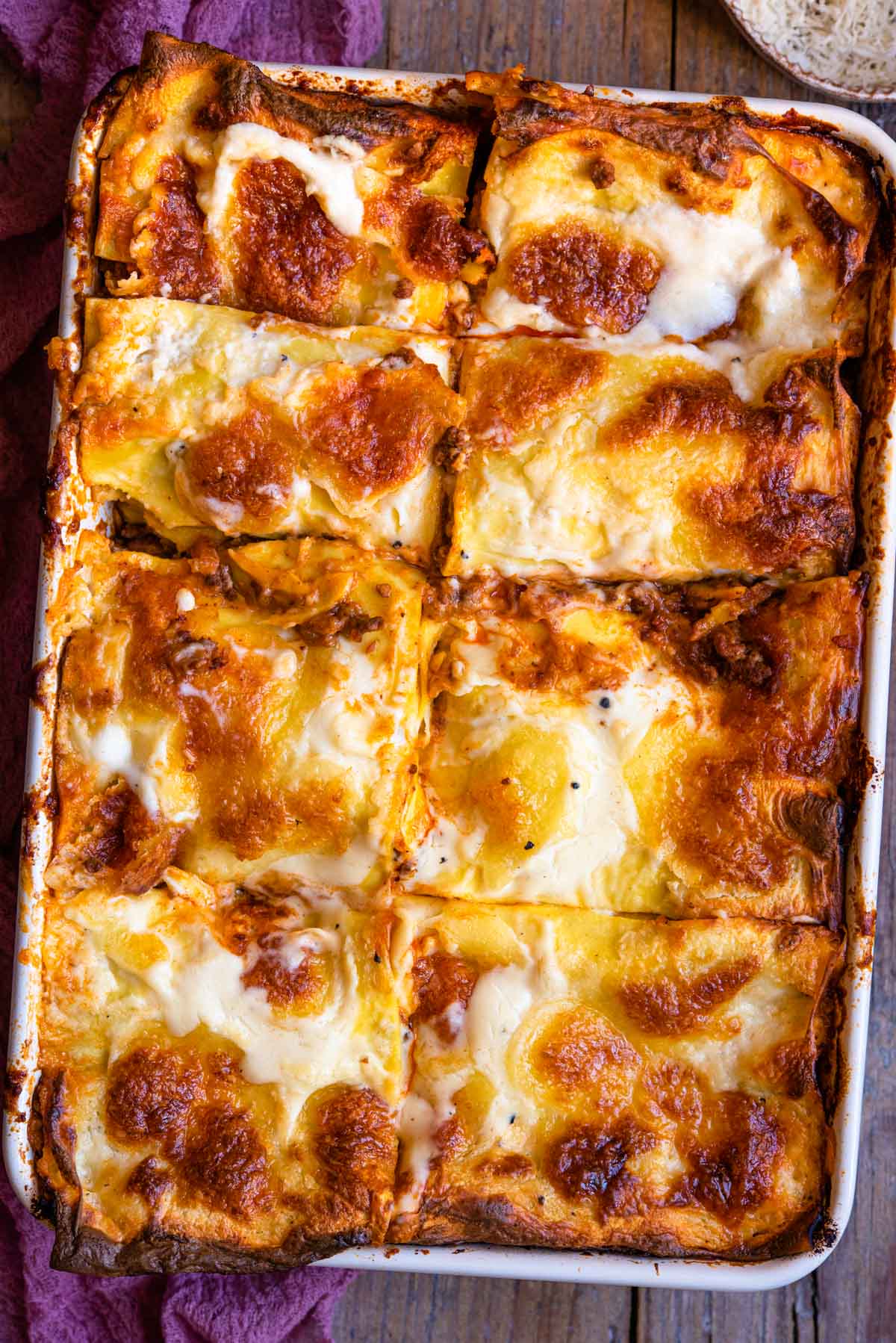 An overhead shot of lasagne al forno in a large baking dish