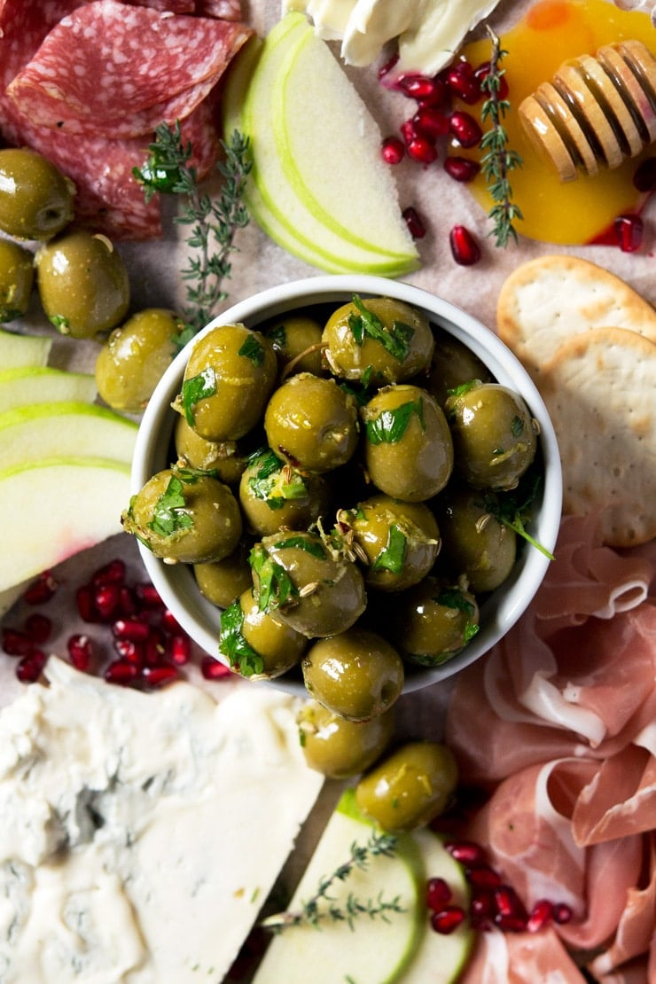 A close up of marinated olives in a ramekin 