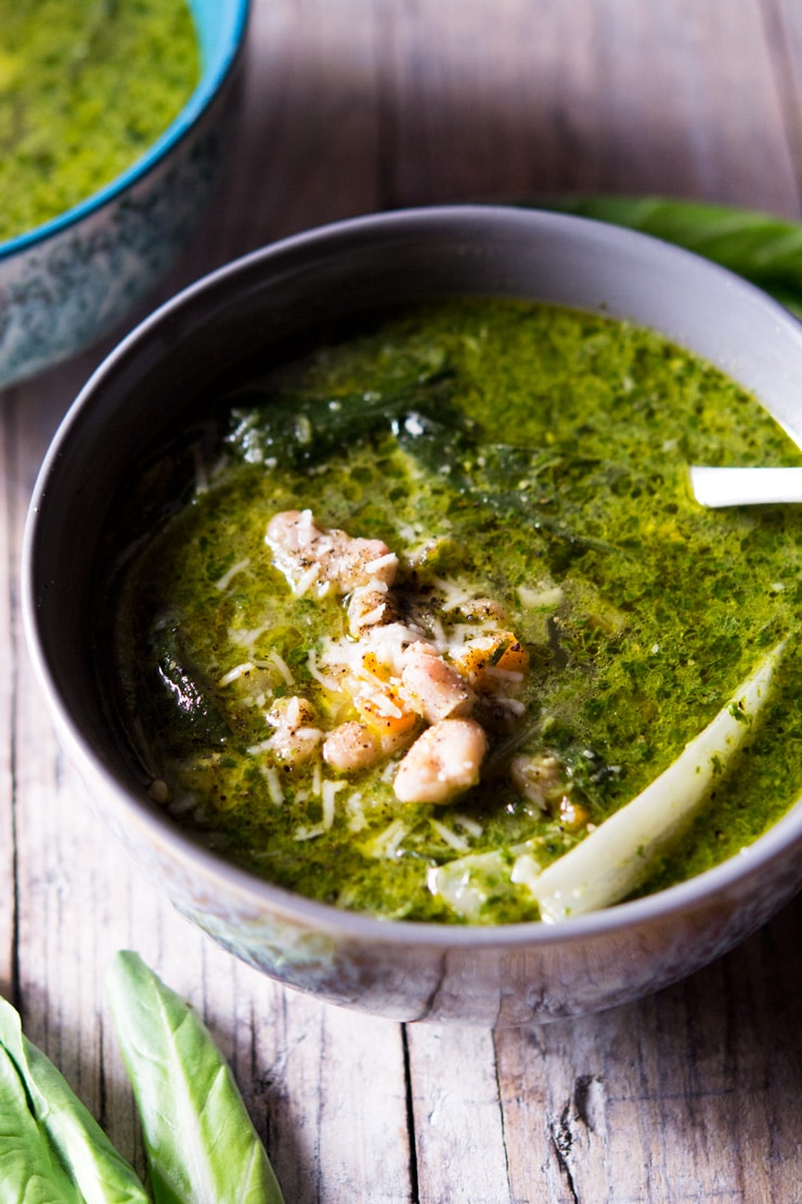 A close up of green soup made with pesto and cannellini beans