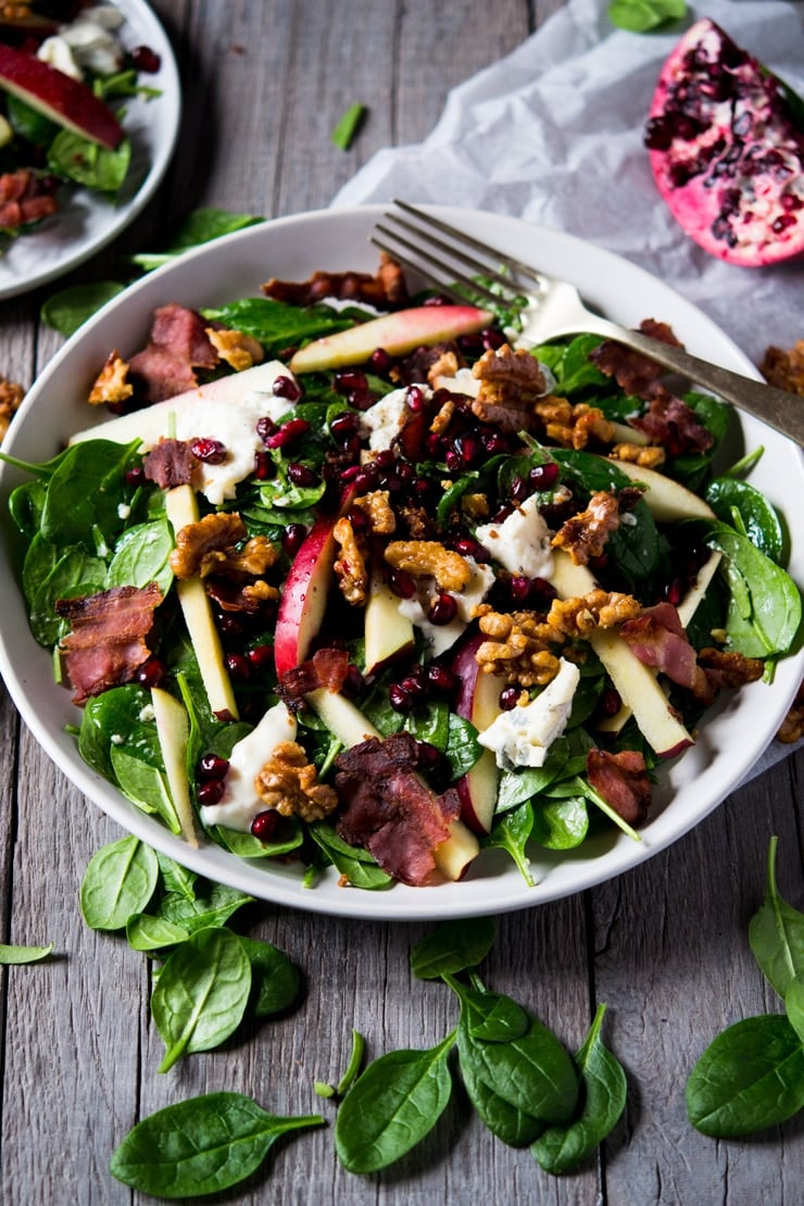 A winter salad made with spinach, gorgonzola cheese, apple and candied walnuts
