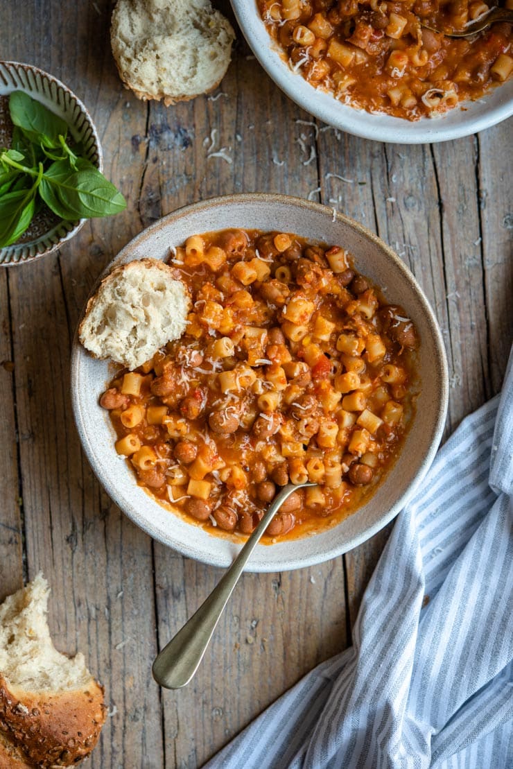 A bowl of pasta fagioli soup with crusty bread