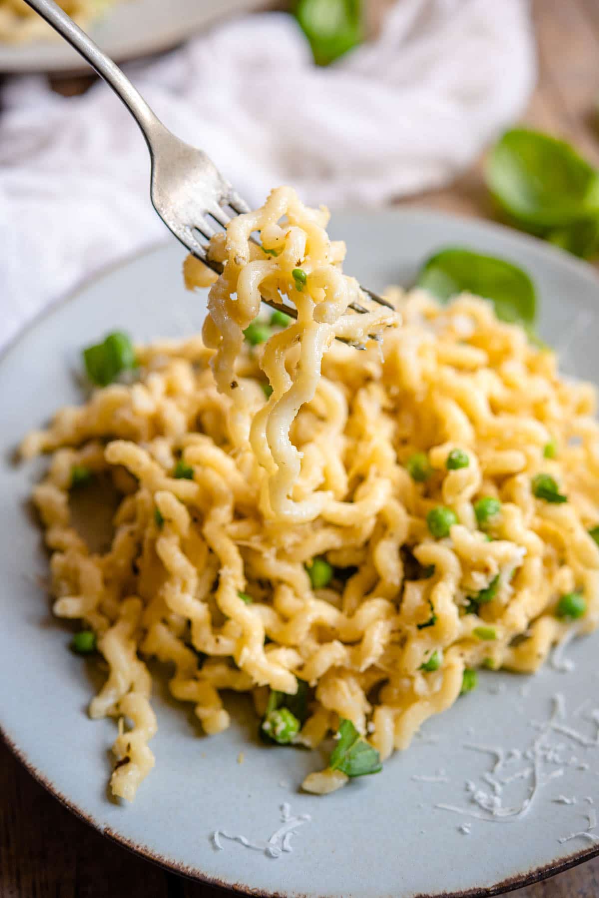 A close up of artichoke pasta on a fork