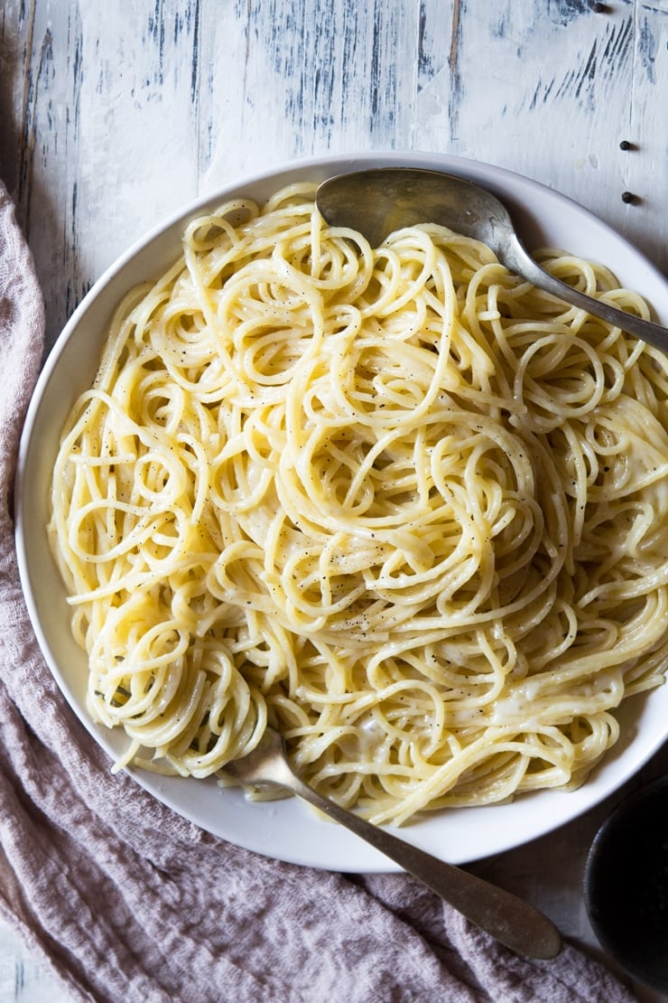 An overhead shot of cacio e pepe recipe in a plate with a fork