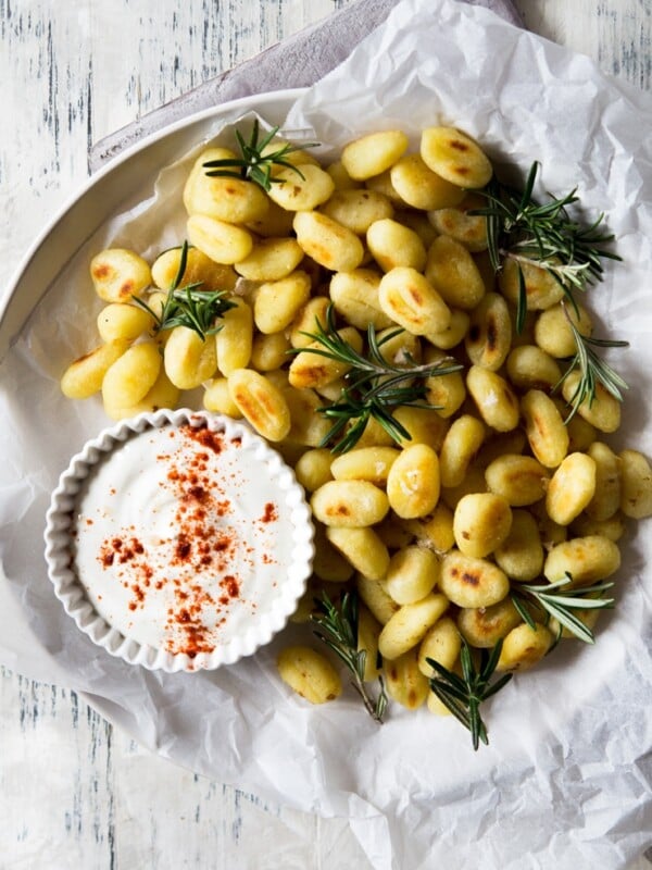 Pan fried gnocchi with a sour cream dip on a plate