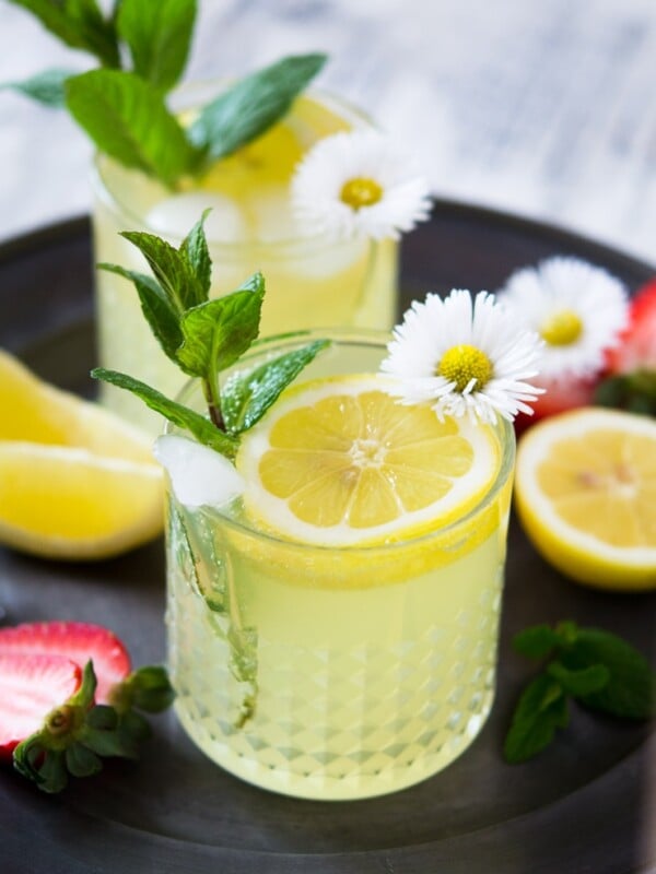 a limoncello cocktail garnished with mint and dasies