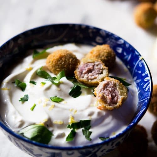 cut open stuffed olives with a sour cream dip
