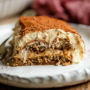 A xlose up of a slice of Tiramisu on a plate
