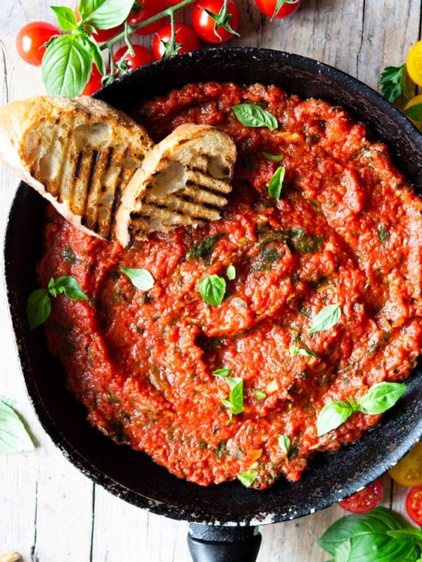Italian tomato sauce in a saucepan with two slices of ciabatta bread