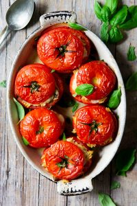 6 stuffed tomatoes in an oval baking dish