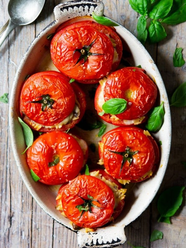 6 stuffed tomatoes in an oval baking dish