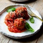 talian meatballs on a rustic plate with tomato sauce and basil