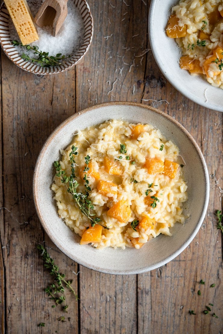 An overhead shot of butternut squash risotto in a rustic bowl