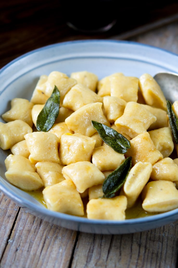 A side shot of gnocchi with a brown butter sage sauce