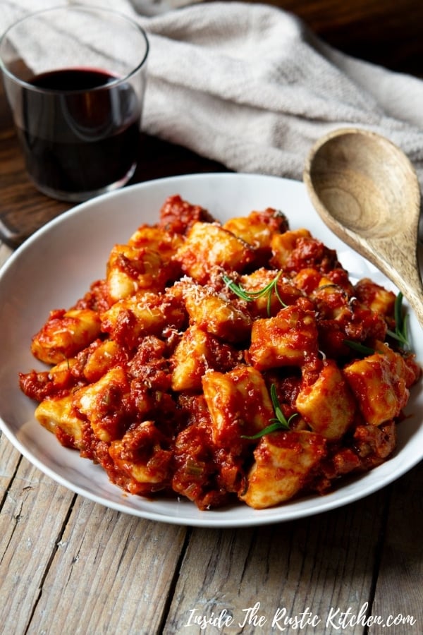 Sausage Ragu with Ricotta Gnocchi. This simple Italian ragu is made with just a few simple ingredients and tastes incredible. Toss it with soft, light ricotta gnocchi and you have the perfect lazy weekend meal. | Authentic Italian Recipes | Traditional Italian Recipes | Easy Ragu | Sausage Pasta Sauce | #Insidetherustickitchen #ragu #sausage #Italian #Italianrecipes