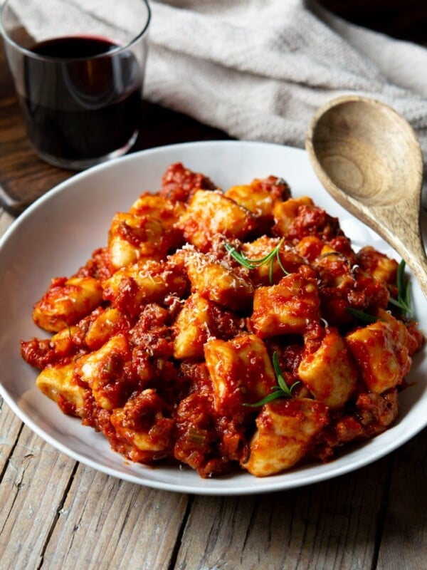 Sausage ragu with ricotta gnocchi in a white bowl