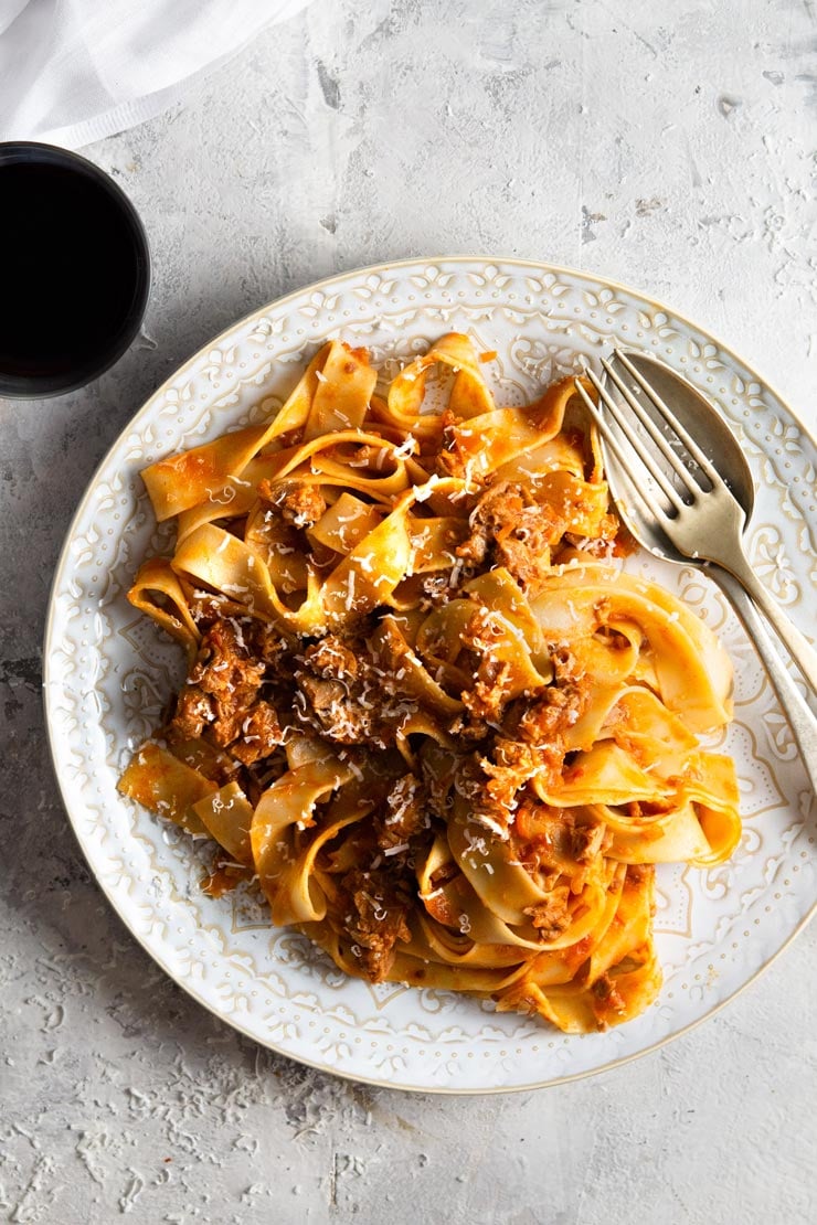 An overhead shot of a bowl of duck ragu with pappardelle pasta