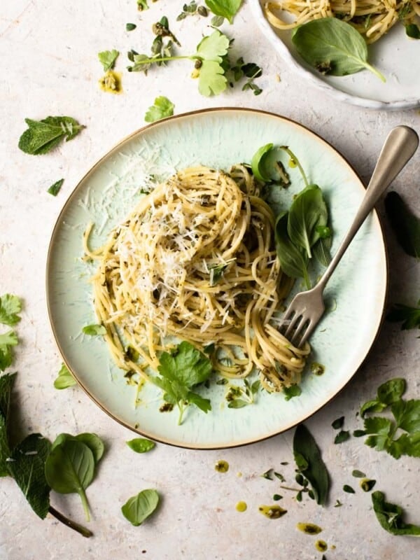 An overhead shot of herb garlic butter pasta sauce with spaghetti