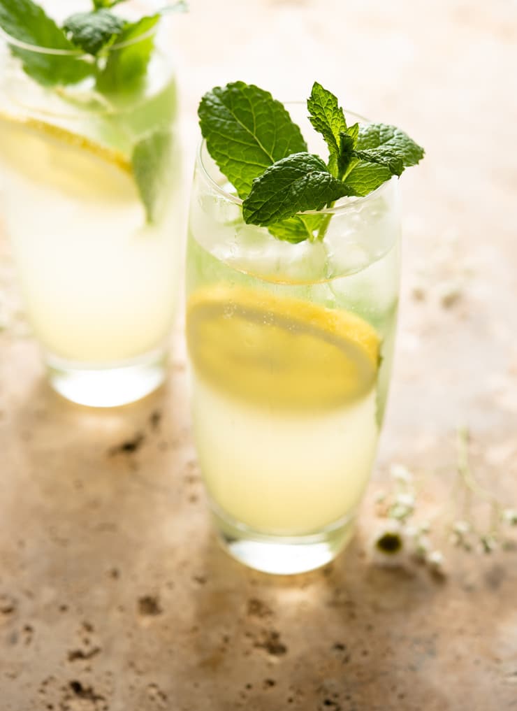 A close up of a mojito cocktail garnished with mint leaves
