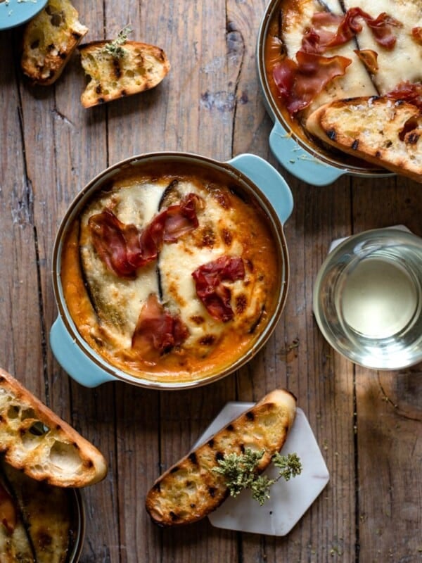 Eggplant lasagna in blue dishes with grilled ciabatta