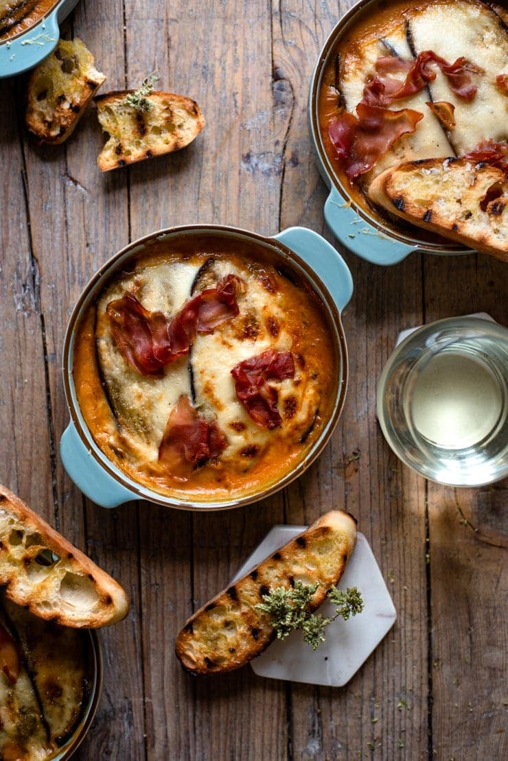 Eggplant lasagna in blue dishes with grilled ciabatta