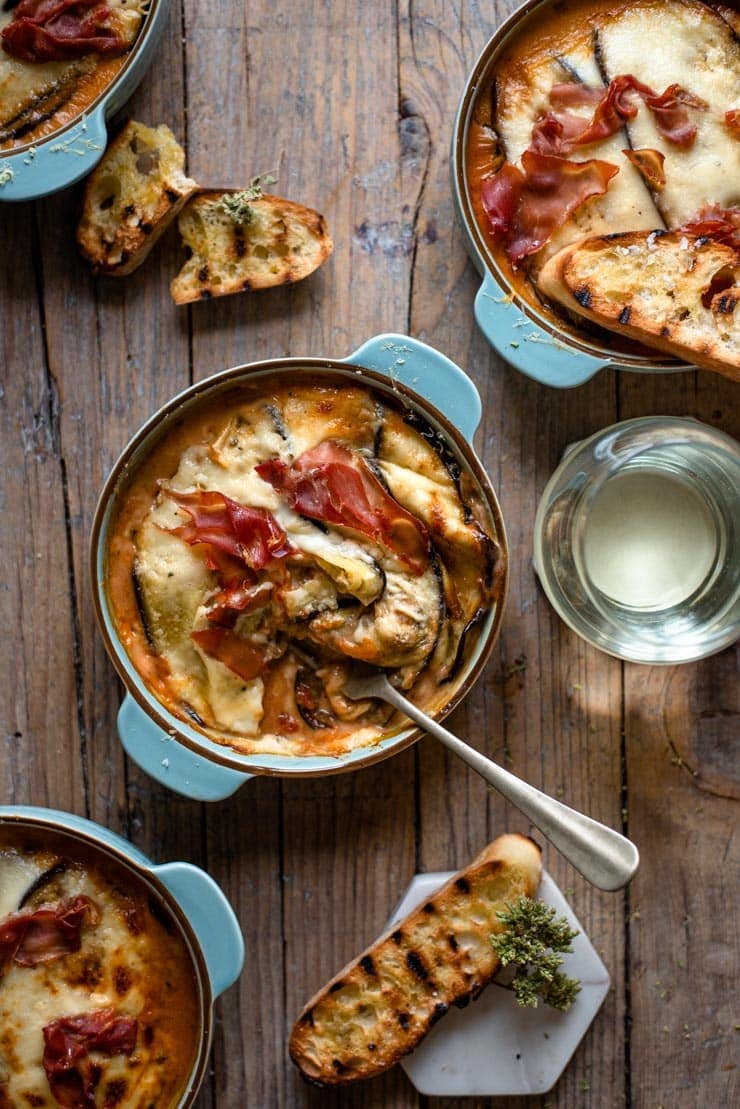 An overhead shot of eggplant lasagna in a blue dish with a fork