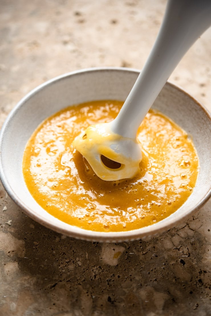 A close up of making peach puree to make a peach bellini cocktail