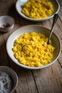 Saffron risotto in a bowl with a fork