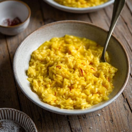 Saffron risotto in a bowl with a fork