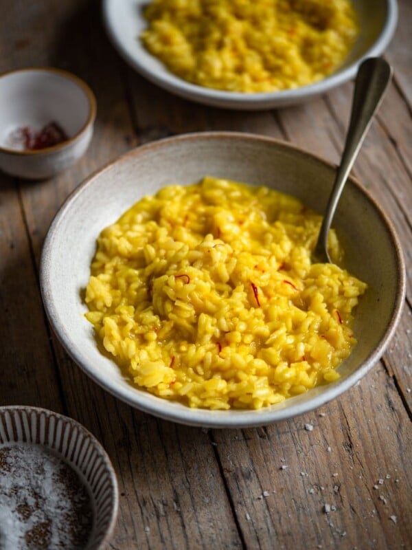 Saffron risotto in a bowl with a fork