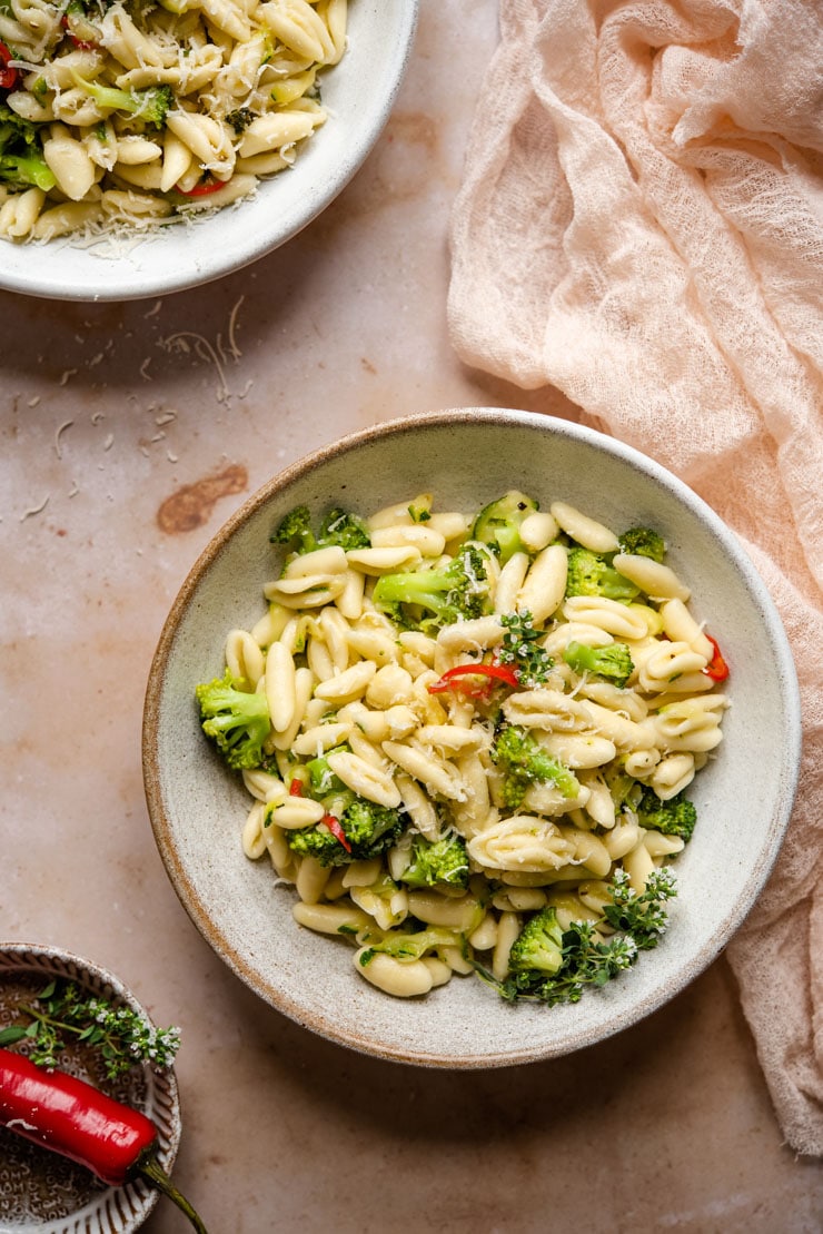 An overhead shot of cavatelli pasta and broccoli in a rustic bowl