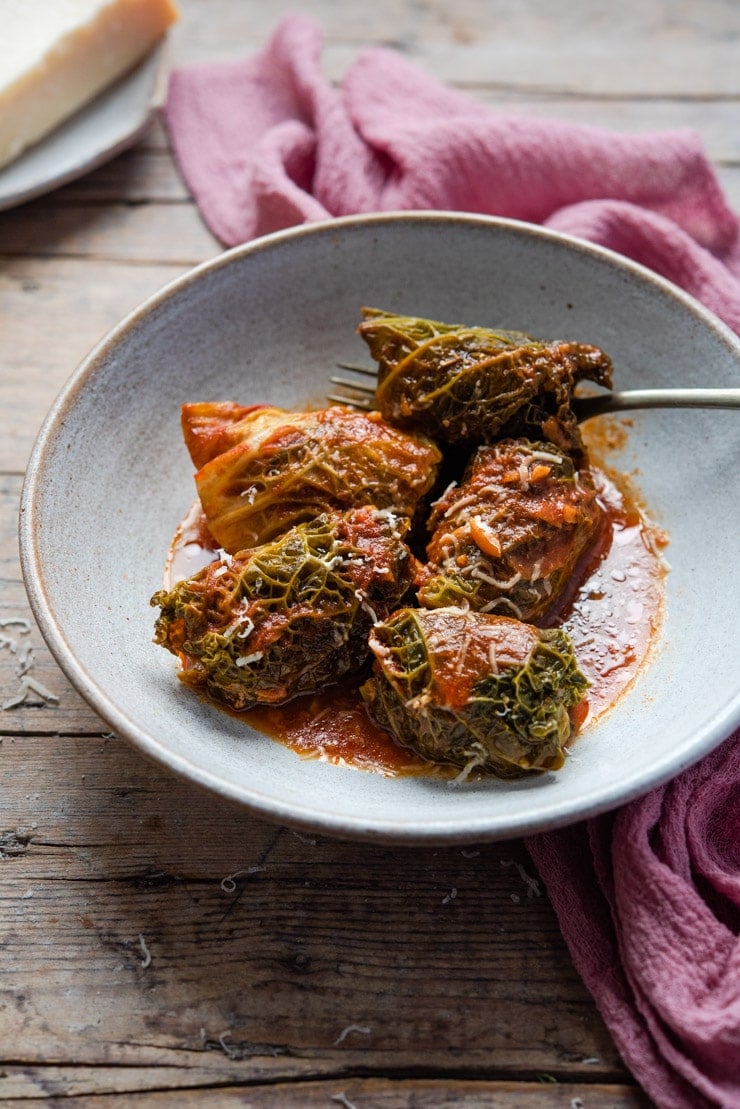 Stuffed cabbage rolls in a bowl with tomato sauce