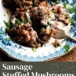 A pinterest graphic for sausage stuffed mushrooms. One mushroom is cut open with a fork.
