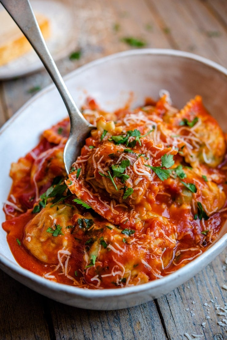 Homemade ravioli tossed with tomato sauce in a bowl