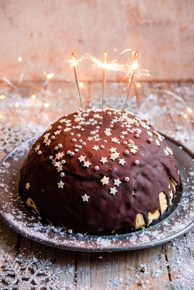 A side shot of a panettone bombe Christmas ice cream cake with sparklers