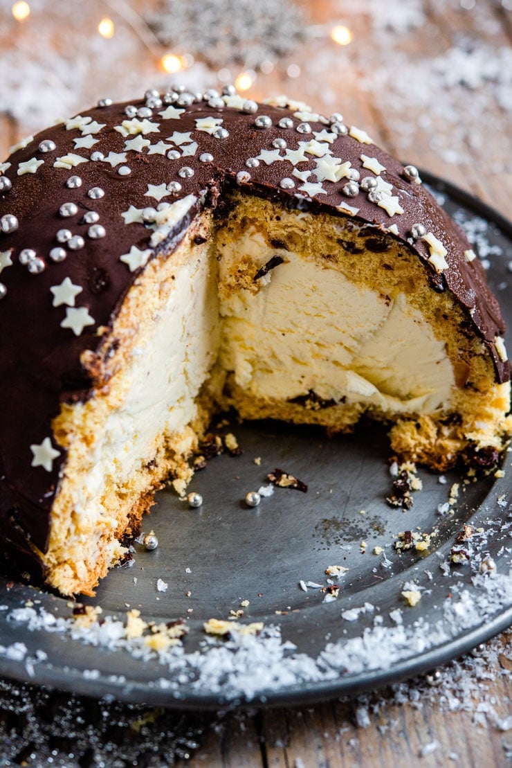 A close up of a panettone bomb Christmas ice cream cake with a slice cut out