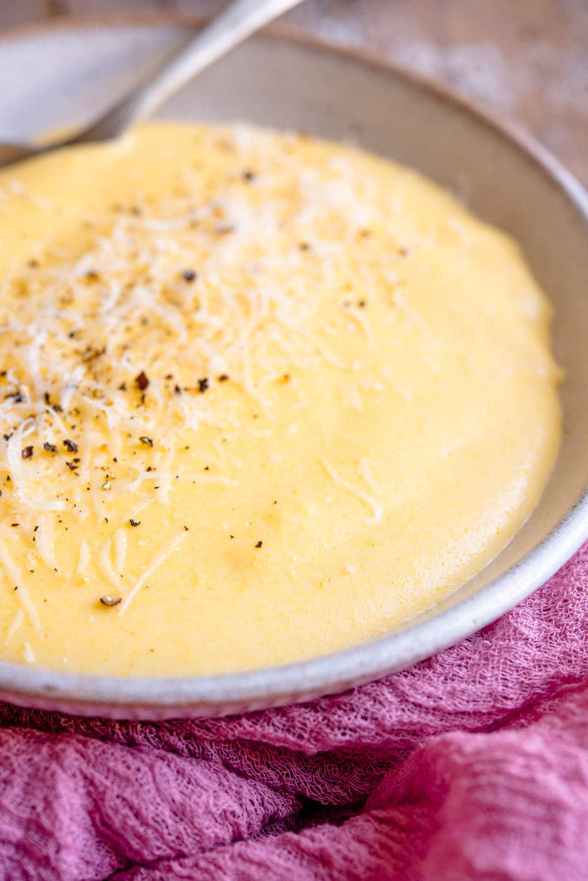 A side shot of creamy polenta in a bowl