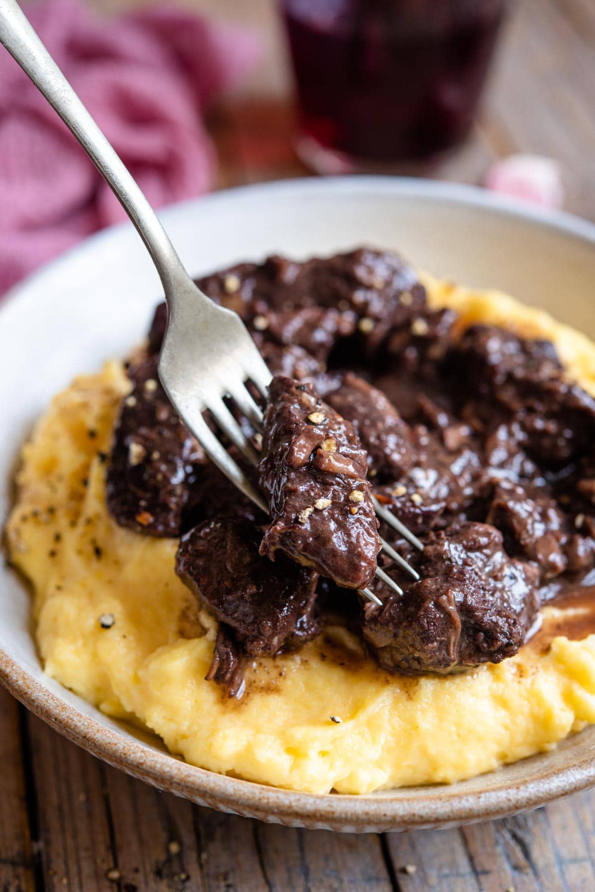 A close up of a piece of stew on a fork