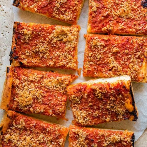 An overhead shot of a pan pizza cut into slices