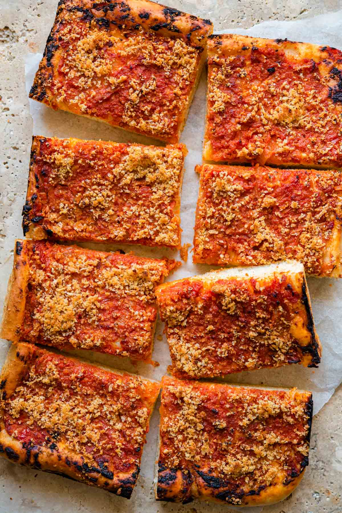 An overhead shot of Sfincione pizza cut into slices