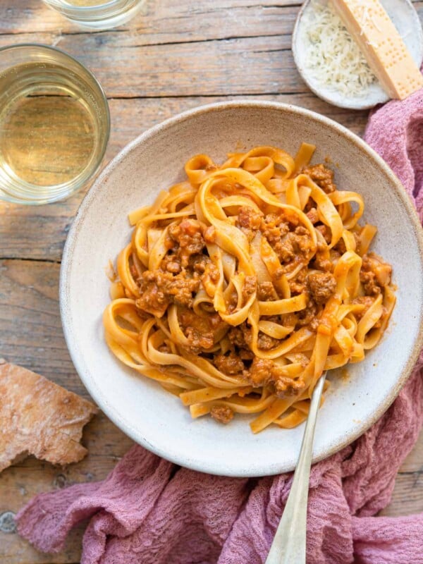 AN overhead shot of tagliatelle bolognese in a rustic bowl