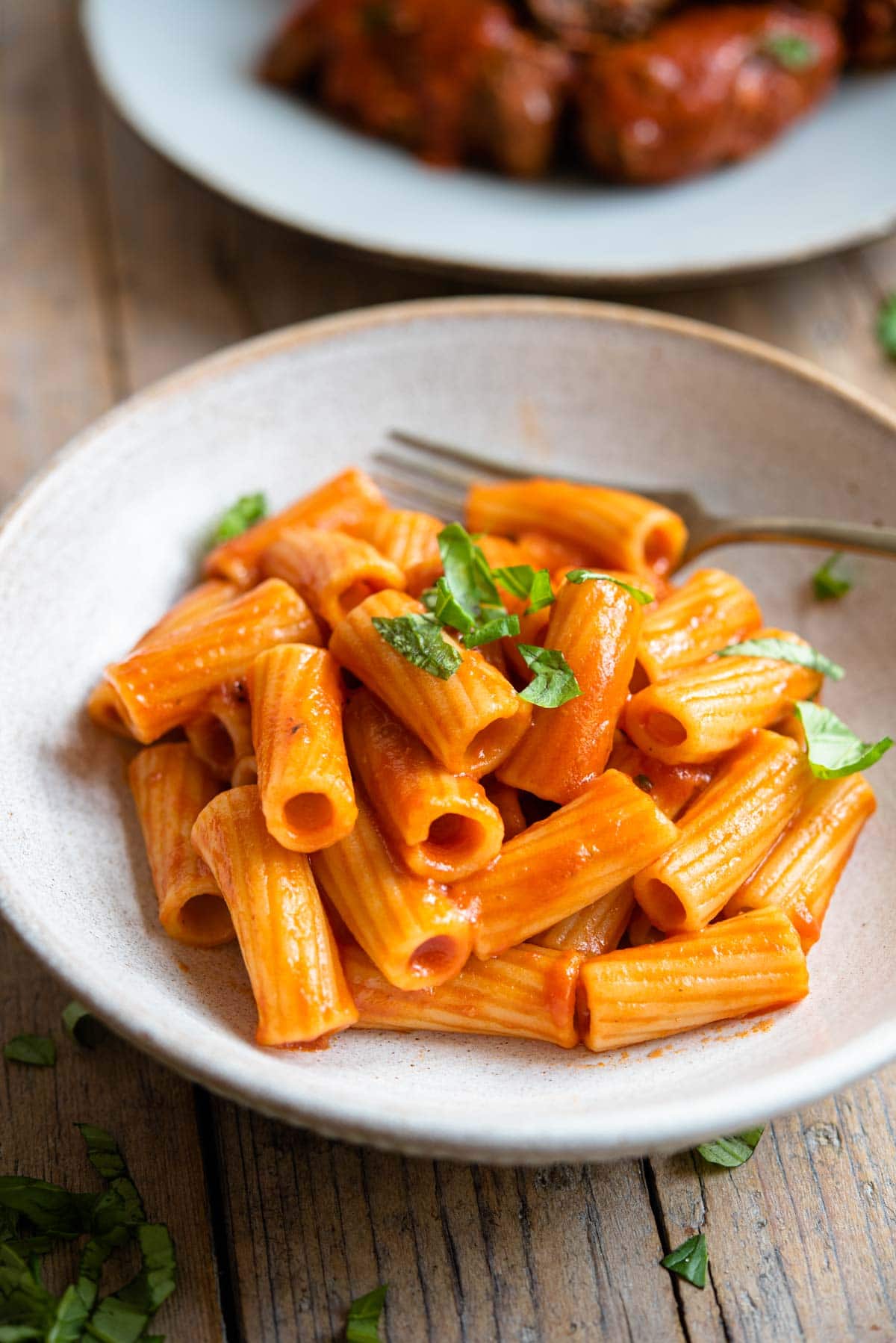 A side shot of pasta with tomato sauce in a bowl