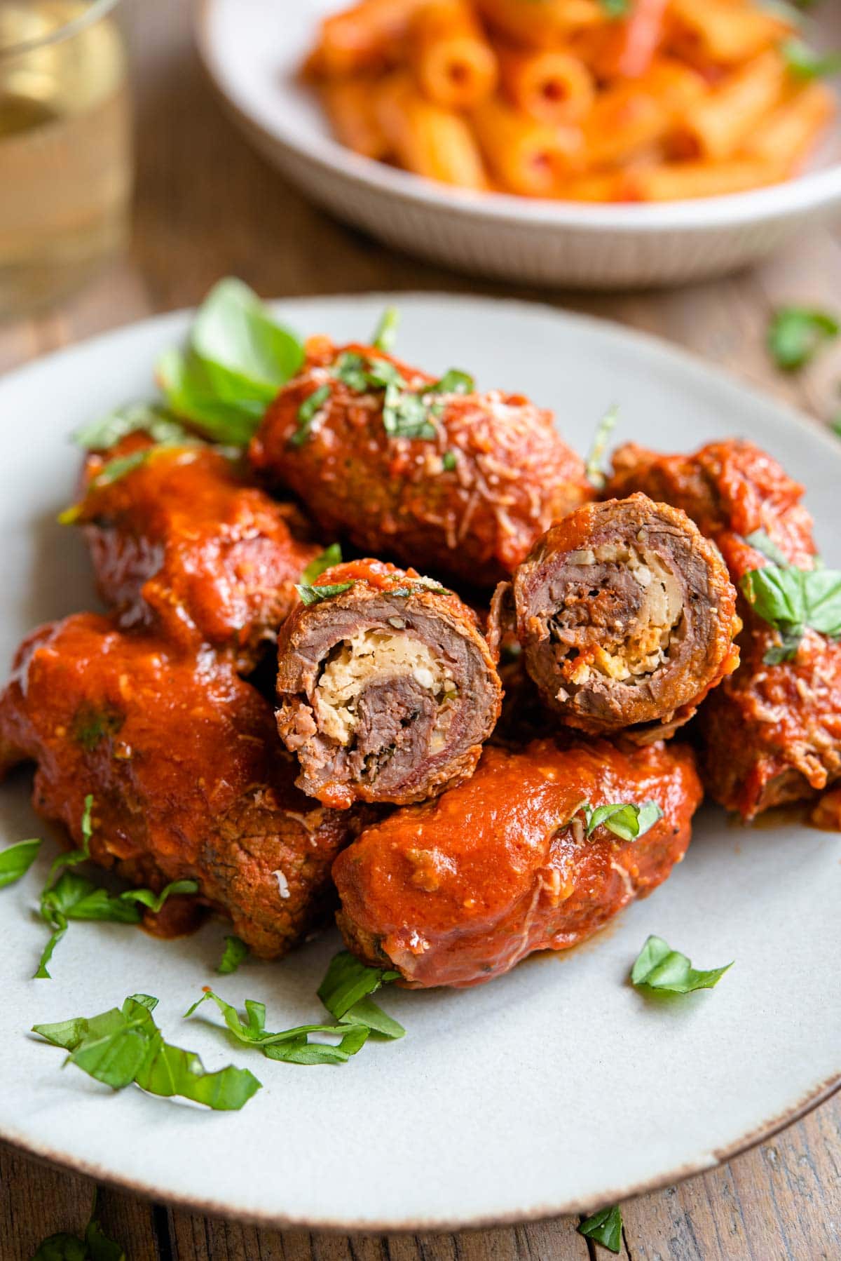 A close up of beef braciole cut in half so you can see the filling