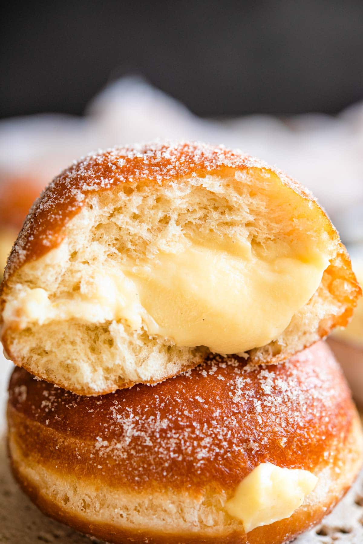 A close up of an Italian doughnut cut in half with a pastry cream filling