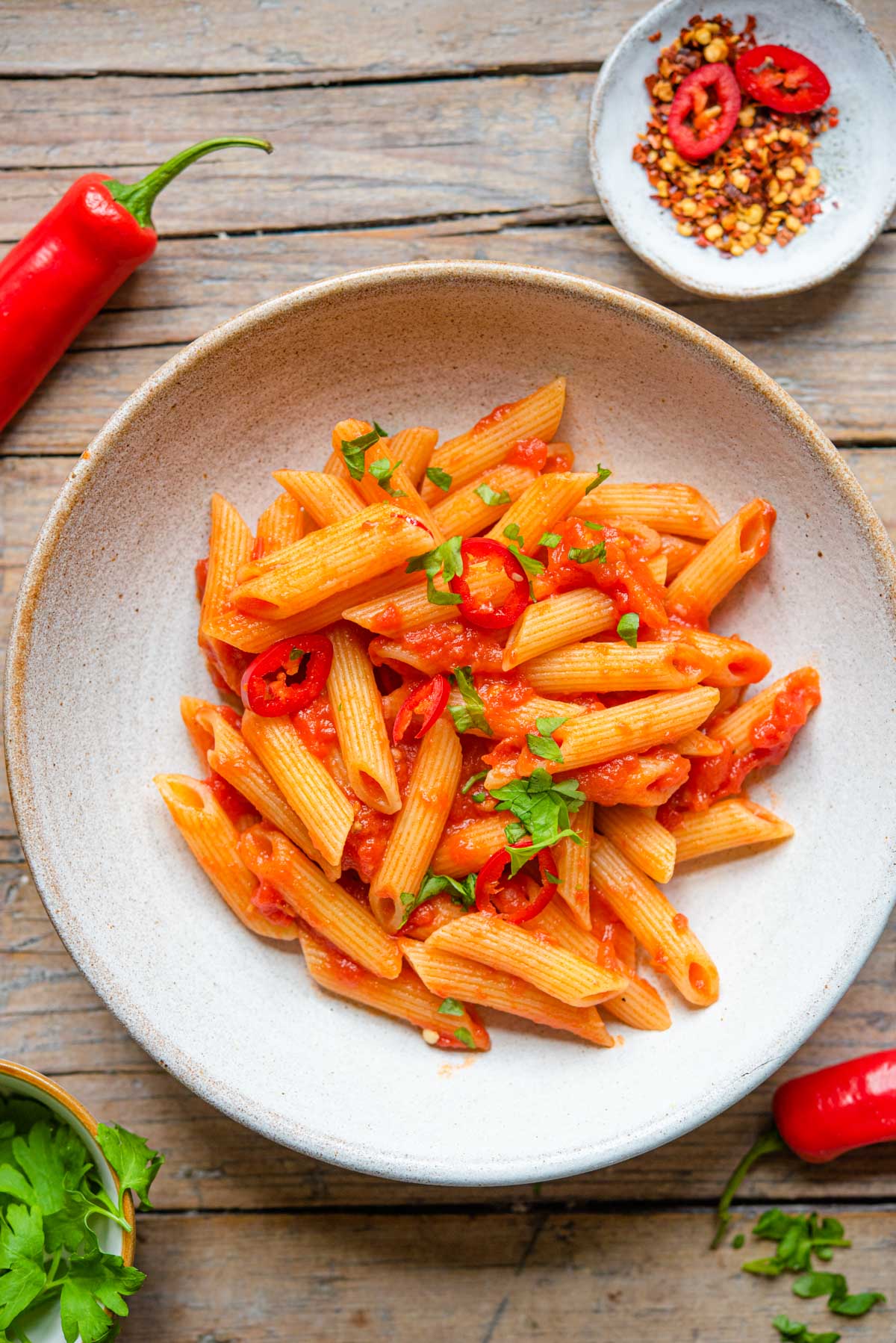 An overhead shot of penne pasta with arrabbiata sauce in a bowl
