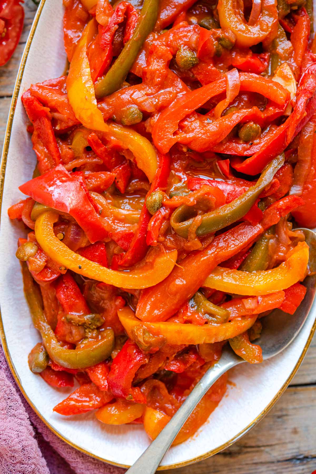 A close up of peppers in tomato sauce on a serving plate