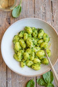 An overhead shot of pesto gnocchi in a bowl