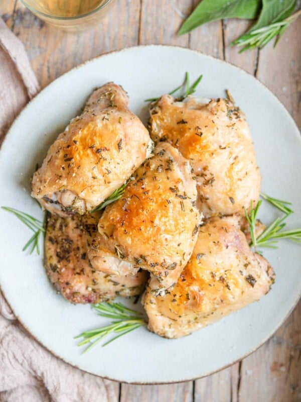 An overhead shot of crispy chicken thighs on a serving plate