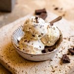 A square image of 3 scoops of ice cream in a rustic dish